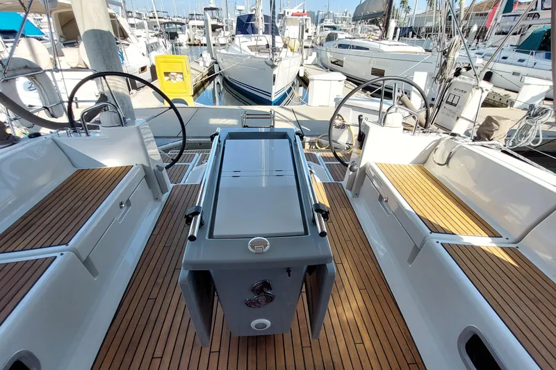 Slide: The Image of Beneteau Oceanis 45 sailboat cockpit with dual steering wheels, docked in a marina, 2015 model. - 27
