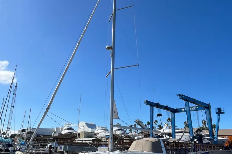 Slide: The Image of 2015 Beneteau Oceanis 45 sailboat docked at a marina under clear blue skies. - 3