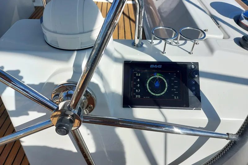 Slide: The Image of Steering wheel and navigation display on 2015 Beneteau Oceanis 45 yacht. - 30