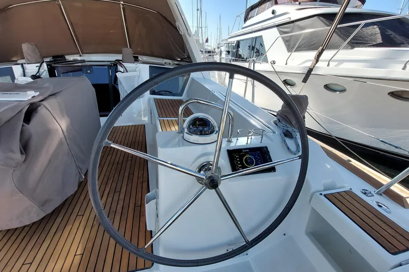 Slide: The Image of Steering wheel of 2015 Beneteau Oceanis 45 yacht with wooden deck and navigation instruments. - 32
