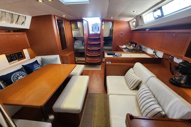 Slide: The Image of Interior of 2015 Beneteau Oceanis 45 yacht with cozy seating and modern kitchen. - 47