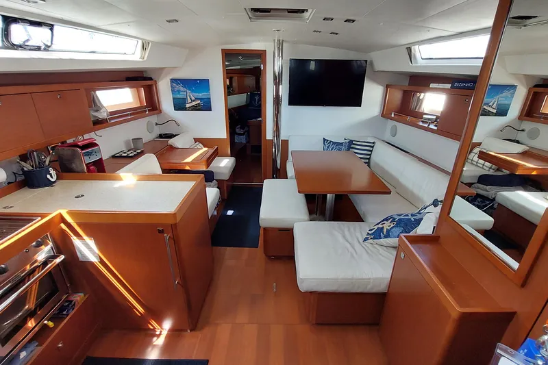 Slide: The Image of Interior of 2015 Beneteau Oceanis 45 yacht with modern kitchen and seating area. - 48