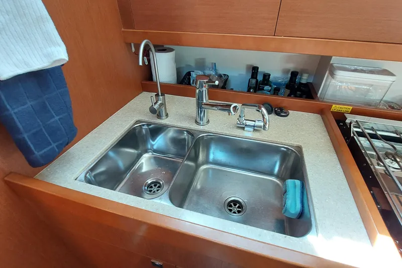 Slide: The Image of Galley sink in 2015 Beneteau Oceanis 45 yacht, featuring dual basins and modern fixtures. - 52