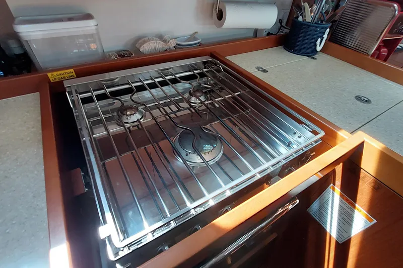 Slide: The Image of Stove in 2015 Beneteau Oceanis 45 yacht kitchen with utensils and countertop. - 53