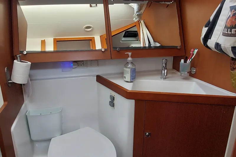 Slide: The Image of Bathroom interior of 2015 Beneteau Oceanis 45 yacht with sink, mirror, and toiletries. - 63