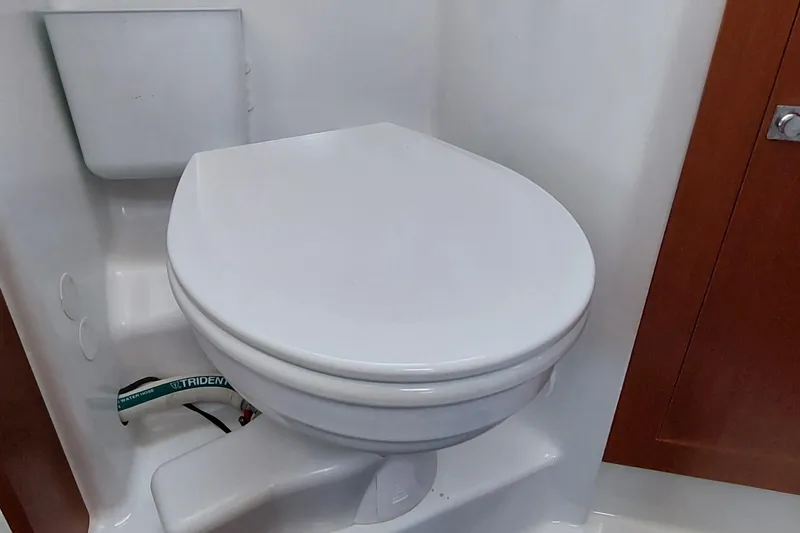 Slide: The Image of Beneteau Oceanis 45 (2015) yacht bathroom with white marine toilet. - 65