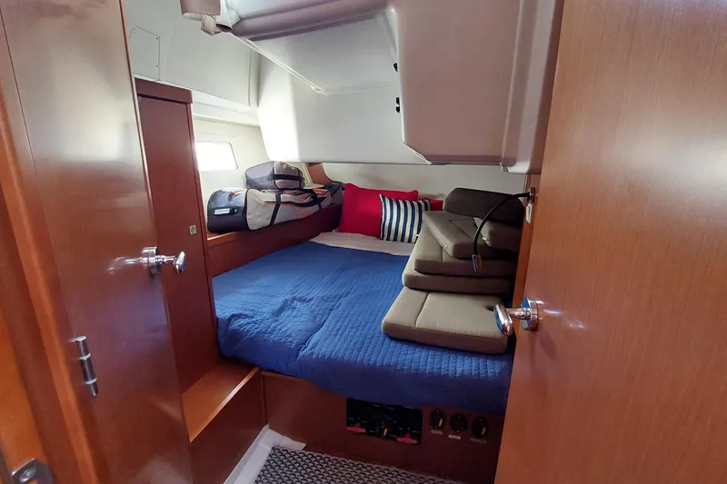 Slide: The Image of Cozy cabin interior of 2015 Beneteau Oceanis 45 yacht with blue bedding and cushions. - 67