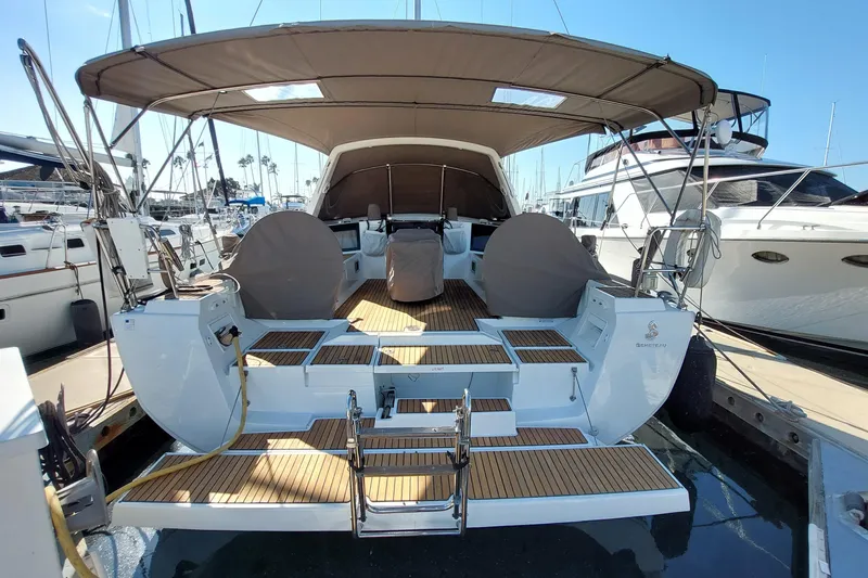 Slide: The Image of 2015 Beneteau Oceanis 45 yacht with spacious deck and canopy in marina. - 7