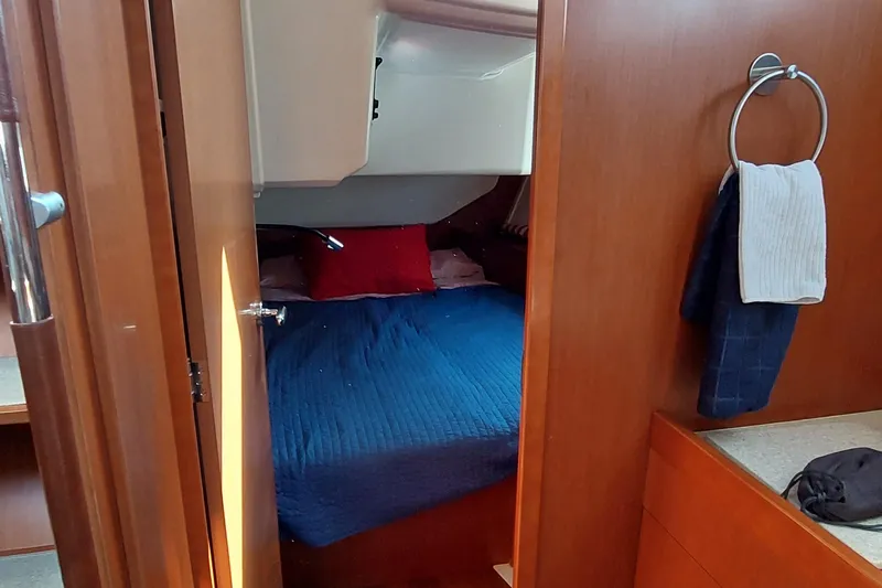 Slide: The Image of Cozy cabin interior of 2015 Beneteau Oceanis 45 sailboat with blue bedding. - 70