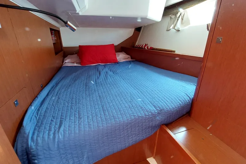 Slide: The Image of Cozy cabin interior of 2015 Beneteau Oceanis 45 with blue bedding and red pillow. - 72