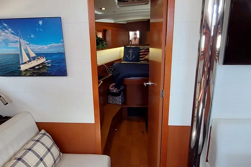 Slide: The Image of Interior of 2015 Beneteau Oceanis 45 yacht with cozy cabin and nautical decor. - 75