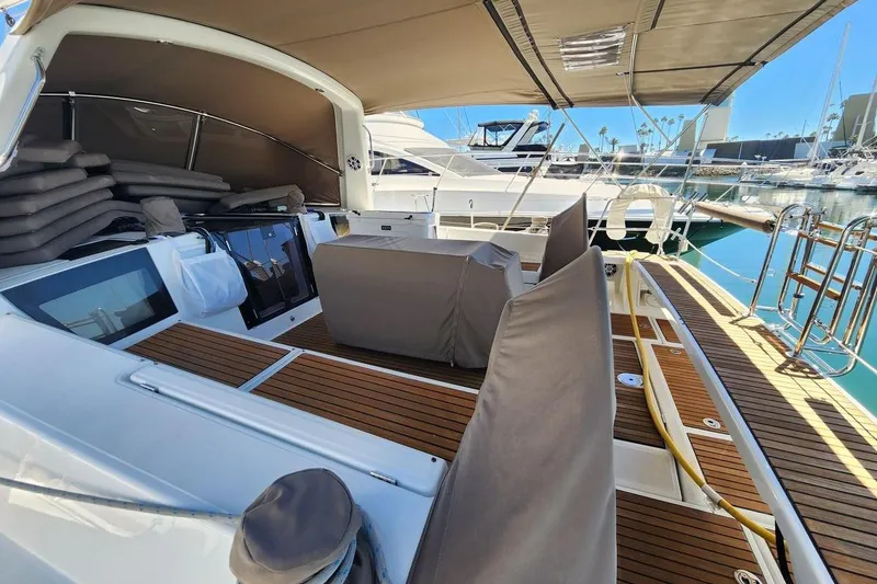 Slide: The Image of 2015 Beneteau Oceanis 45 yacht with spacious deck and seating area in marina. - 8