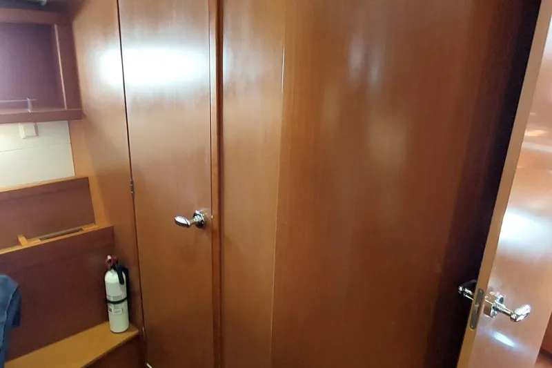 Slide: The Image of Interior of 2015 Beneteau Oceanis 45 yacht with wooden cabinetry and fire extinguisher. - 80