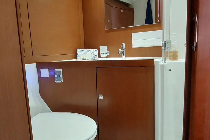 Slide: The Image of 2015 Beneteau Oceanis 45 yacht bathroom with wooden cabinetry and modern fixtures. - 82