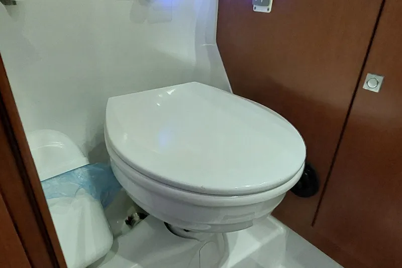 Slide: The Image of Toilet in 2015 Beneteau Oceanis 45 yacht bathroom, featuring wooden cabinetry. - 85