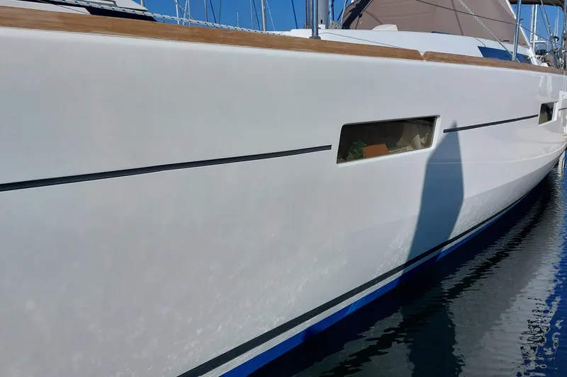 Slide: The Image of 2015 Beneteau Oceanis 45 yacht side view, docked in calm waters. - 9