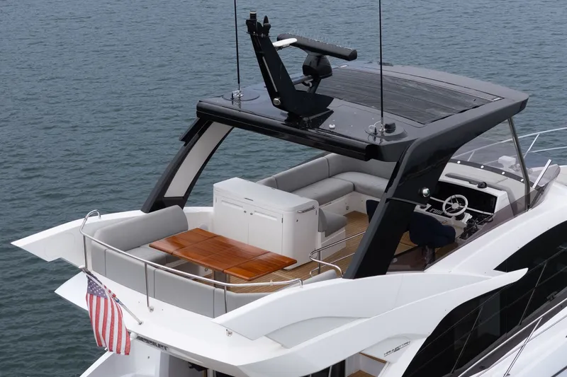 Slide: The Image of Sunseeker Manhattan 55 yacht, 2021 model, featuring a sleek design and spacious deck area. - 15