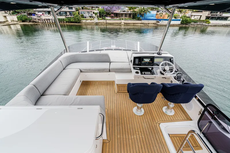 Slide: The Image of Flybridge of 2021 Sunseeker Manhattan 55 yacht with seating and helm station. - 17