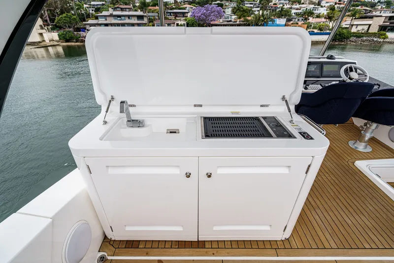 Slide: The Image of Outdoor kitchen on 2021 Sunseeker Manhattan 55 yacht, featuring grill and sink. - 21
