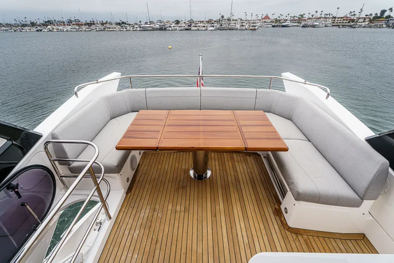 Slide: The Image of Luxurious Sunseeker Manhattan 55 yacht deck with elegant seating and wooden table, 2021 model. - 23