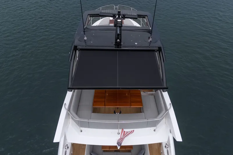 Slide: The Image of 2021 Sunseeker Manhattan 55 yacht, aerial view, sleek design, on calm water. - 27