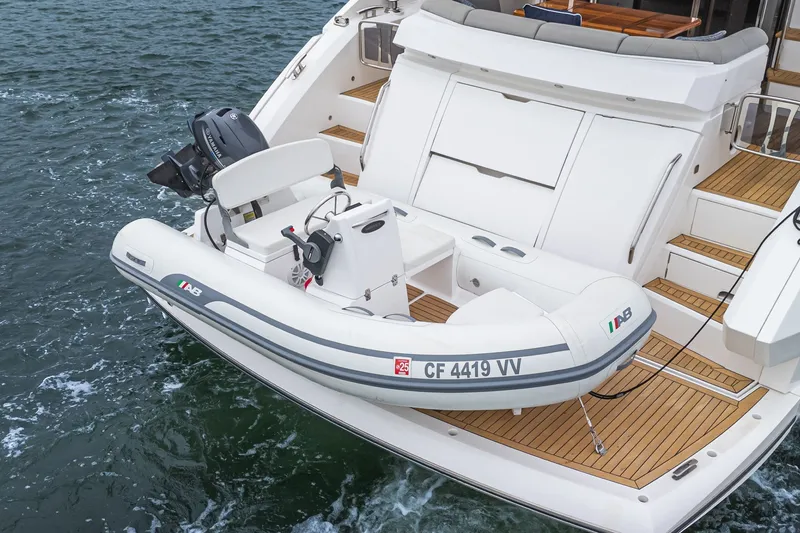 Slide: The Image of 2021 Sunseeker Manhattan 55 yacht with tender boat on water. - 29