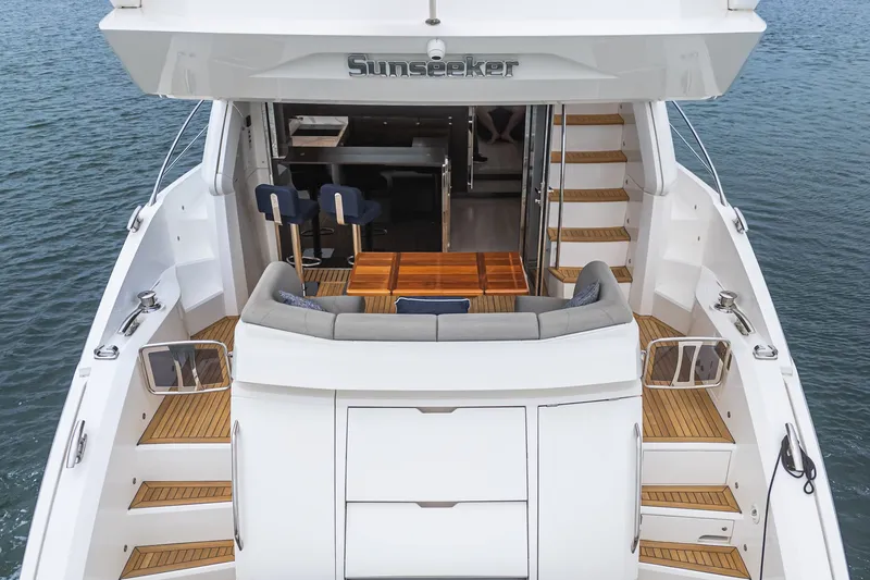 Slide: The Image of Sunseeker Manhattan 55 yacht, 2021 model, featuring elegant deck and seating area. - 32
