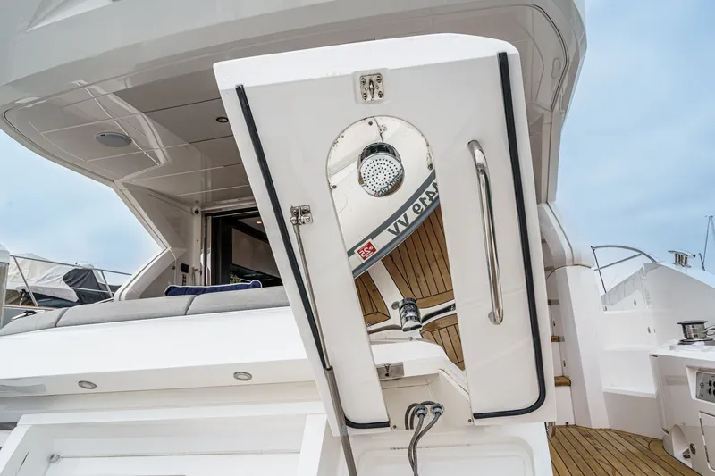 Slide: The Image of 2021 Sunseeker Manhattan 55 yacht with open hatch and teak deck details. - 34