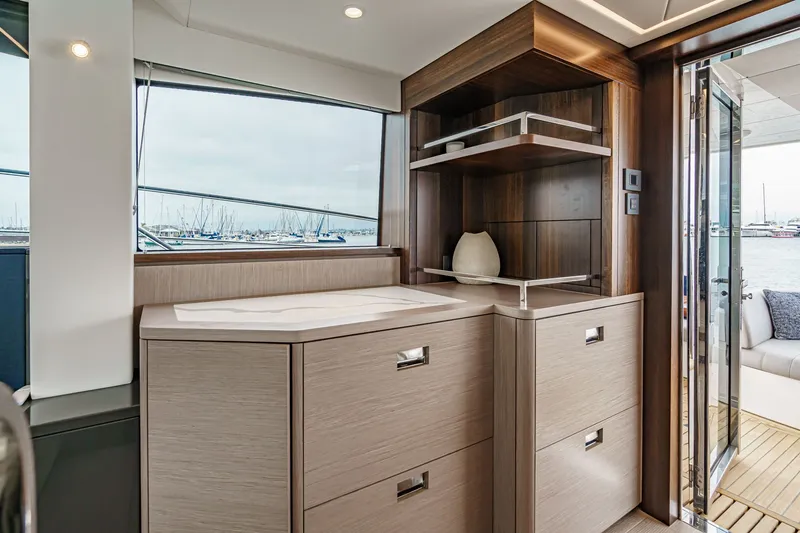 Slide: The Image of Interior of 2021 Sunseeker Manhattan 55 yacht with elegant cabinetry and marina view. - 48