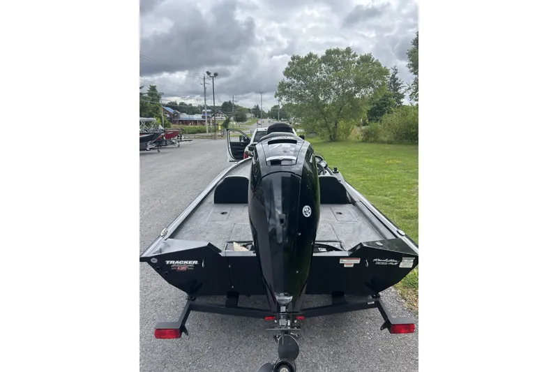 Slide: The Image of 2023 Tracker Pro Team 175 TXW boat on trailer, parked outdoors under cloudy sky. - 4