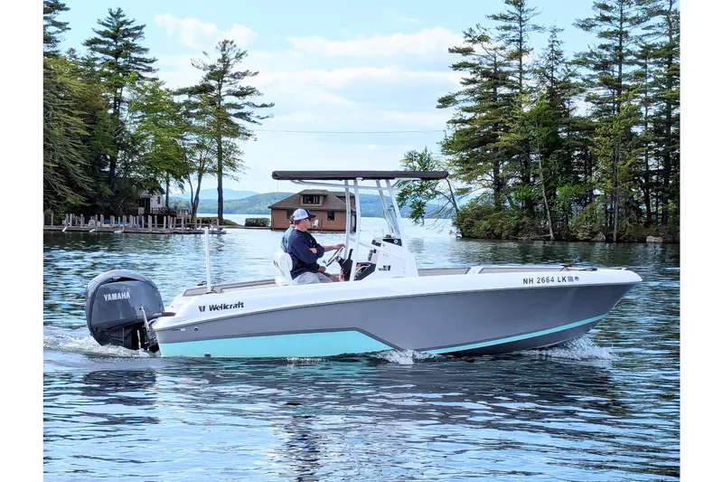 The Image of 2025 Wellcraft 202 Fisherman boat cruising on a scenic lake with trees in the background. - 0