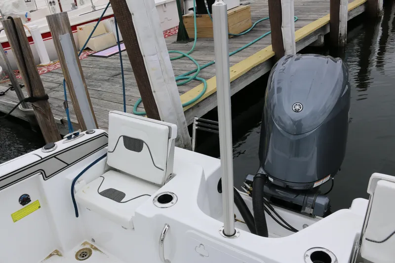 Slide: The Image of 2025 Wellcraft 202 Fisherman boat with outboard motor docked at marina. - 13