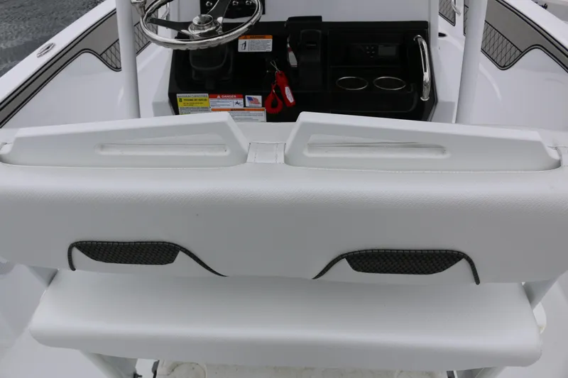 Slide: The Image of 2025 Wellcraft 202 Fisherman boat console with steering wheel and seating. - 16