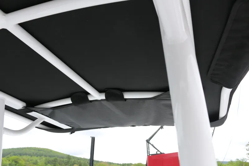 Slide: The Image of 2025 Wellcraft 202 Fisherman boat canopy with white frame and black cover. - 19