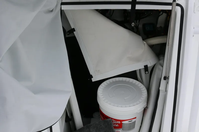 Slide: The Image of Interior storage of 2025 Wellcraft 202 Fisherman boat with bucket and equipment. - 24