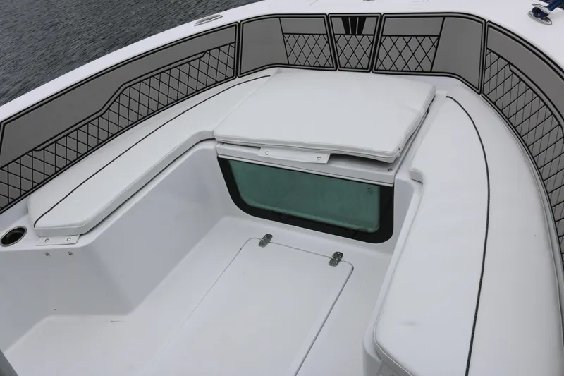 Slide: The Image of 2025 Wellcraft 202 Fisherman boat interior with cushioned seating and storage compartments. - 35