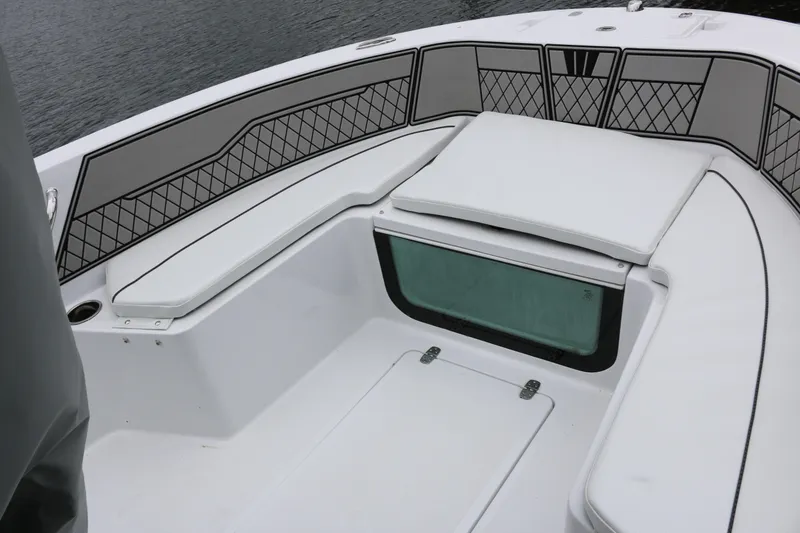 Slide: The Image of 2025 Wellcraft 202 Fisherman boat interior with cushioned seating and storage compartments. - 38