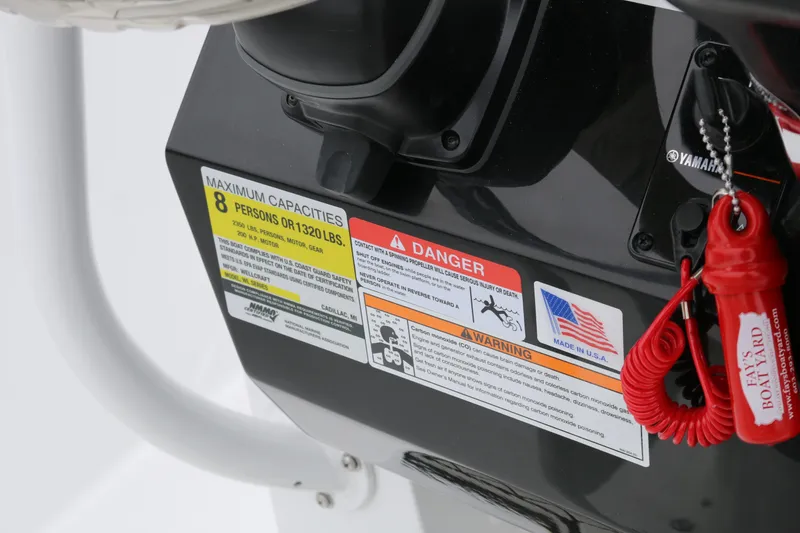 Slide: The Image of Control panel of 2025 Wellcraft 202 Fisherman boat with safety warnings and capacity details. - 44