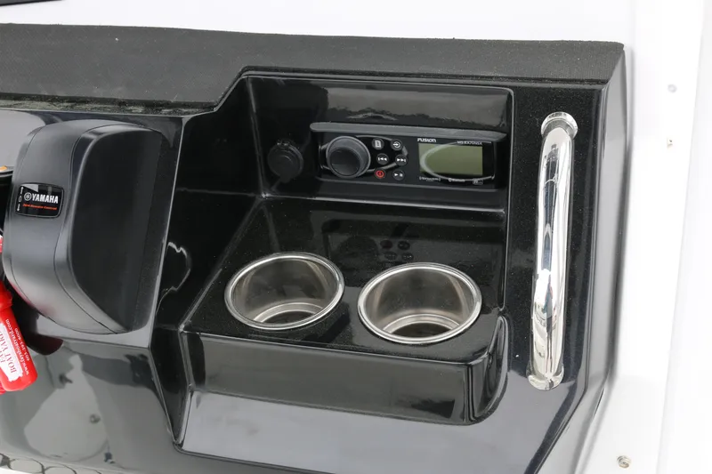 Slide: The Image of Control panel of 2025 Wellcraft 202 Fisherman boat with Yamaha throttle and Fusion stereo. - 49