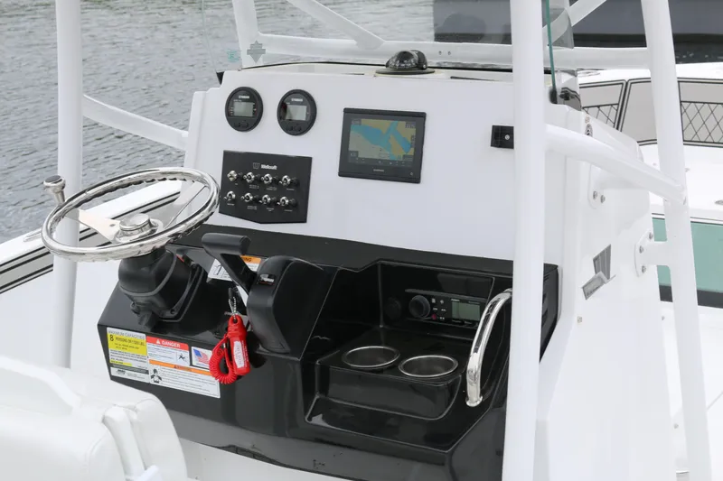 Slide: The Image of Center console of 2025 Wellcraft 202 Fisherman boat with steering wheel and navigation controls. - 5