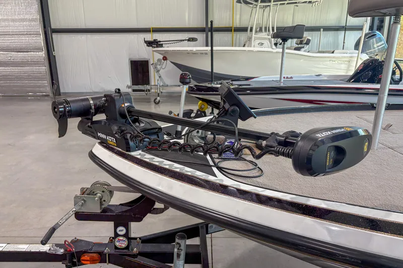 Slide: The Image of 2013 Nitro Z6 boat with Minn Kota trolling motor in a garage setting. - 10