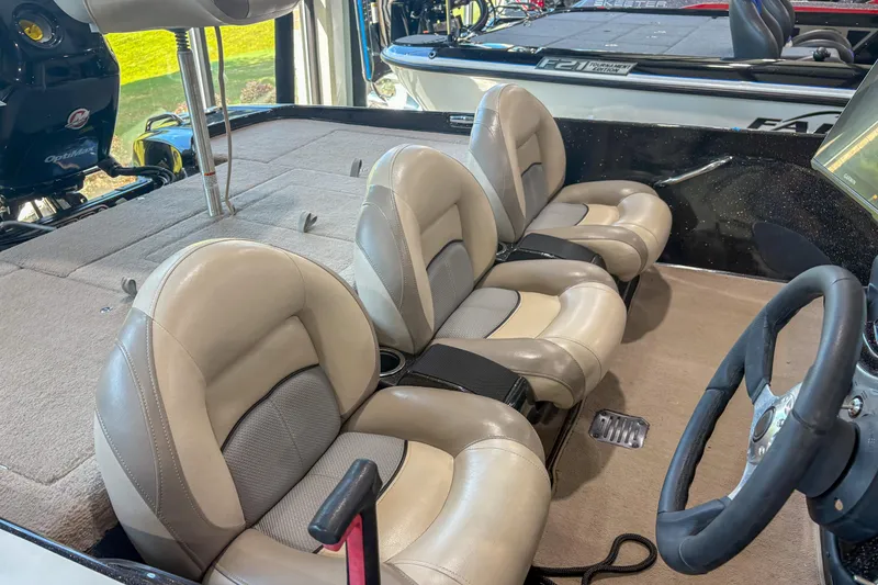 Slide: The Image of Interior of a 2013 Nitro Z6 boat with beige and gray seating. - 11