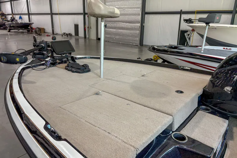 Slide: The Image of 2013 Nitro Z6 boat interior with fishing seat and equipment in a storage facility. - 7