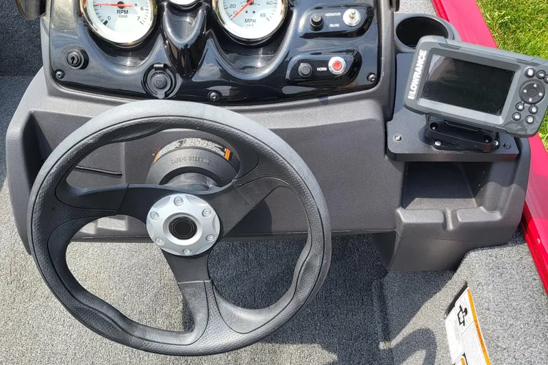 Slide: The Image of 2024 Tracker Pro 170 boat dashboard with steering wheel and navigation system. - 4