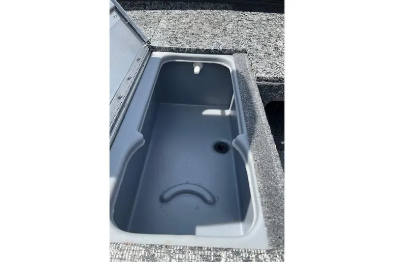 Slide: The Image of 2024 Tracker Pro 170 boat storage compartment, open and empty, with gray interior. - 11
