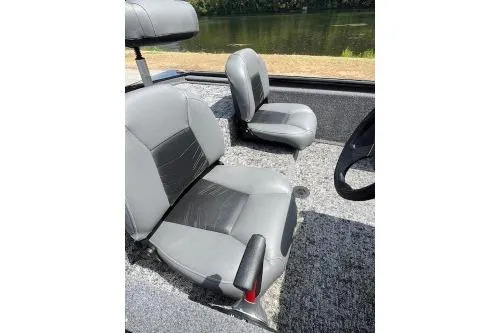 Slide: The Image of 2024 Tracker Pro 170 boat with 50 HP motor, parked near a scenic waterfront. - 6