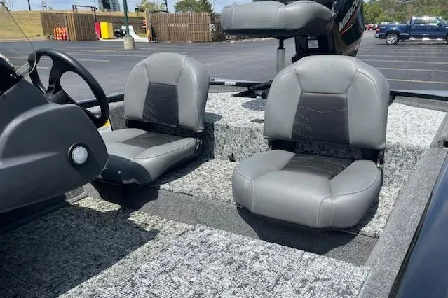 Slide: The Image of 2024 Tracker Pro 170 boat interior with gray seating in a parking lot. - 9