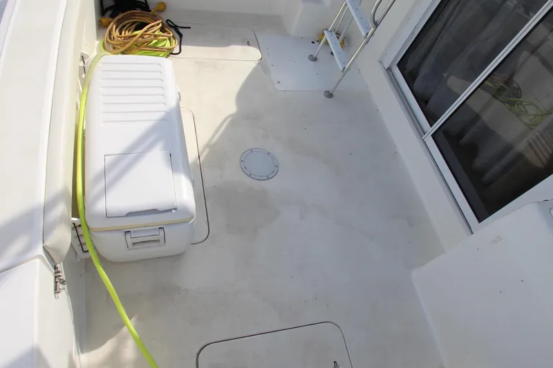 Slide: The Image of 2000 Silverton 37 Convertible boat deck with storage box and coiled rope. - 10