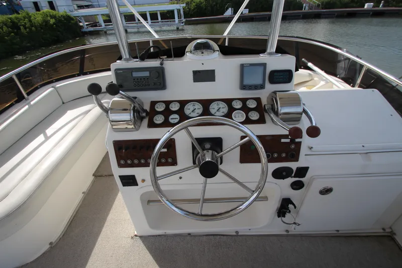 Slide: The Image of 2000 Silverton 37 Convertible yacht helm with steering wheel and control panel. - 16