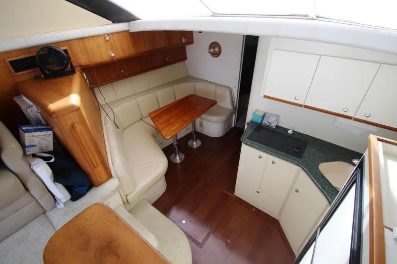 Slide: The Image of Interior of 2000 Silverton 37 Convertible yacht with kitchen and seating area. - 25